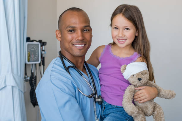 istock Nurse holding child 667831696