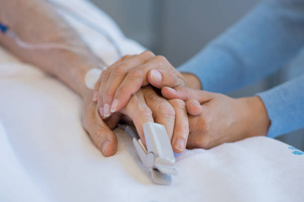Take care of old patient Daughter holding the hand of an elderly father. Closeup of woman holding senior man hand in hospital. Close up of nurse holding old man hand with oxygen saturated probe on finger. cancer illness stock pictures, royalty-free photos & images