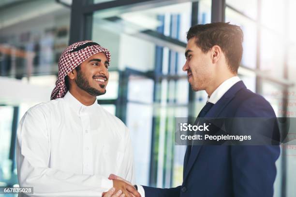 Business Built On A Mutual Purpose Stock Photo - Download Image Now - Arabia, Handshake, West Asian Ethnicity