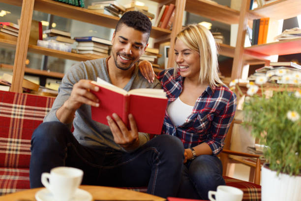 istock Young Multi-ethnic student couple enjoy  book reading in the library. 667835586