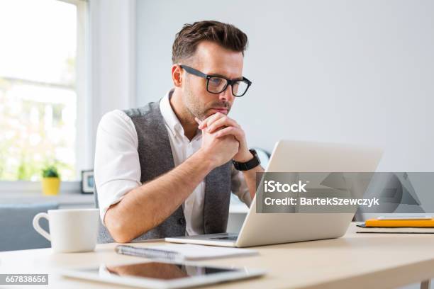 Man In Glasses Working On Laptop From Home Stock Photo - Download Image Now - Laptop, Men, E-Learning