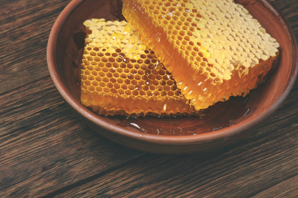 istock honey on a wooden table, above view 667846552