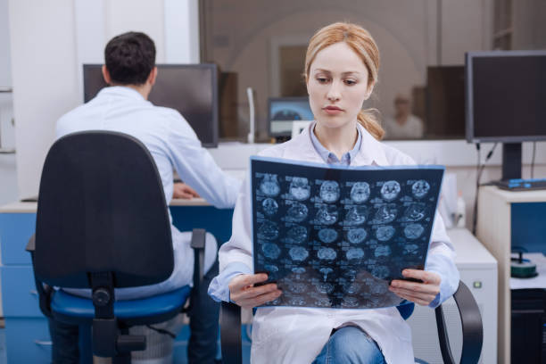 istock Nice female doctor examining X ray image 667848810