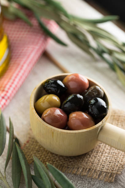 istock Close up olives and olive oil leaves. 667848832