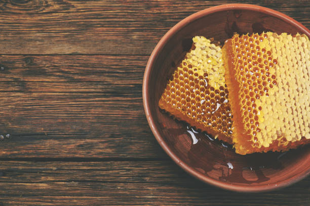 istock honey on a wooden table, above view 667849570