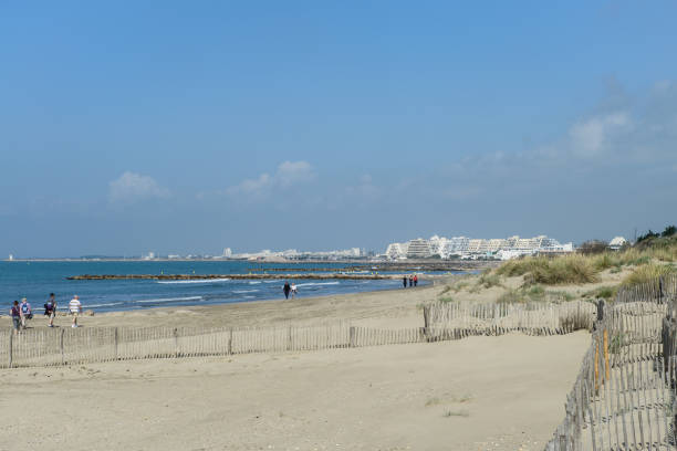 La Grande Motte,France,10 La Grande Motte, France - May 22, 2014:Tourists walk on the beach with the architectural features in the background casa in affitto stock pictures, royalty-free photos & images