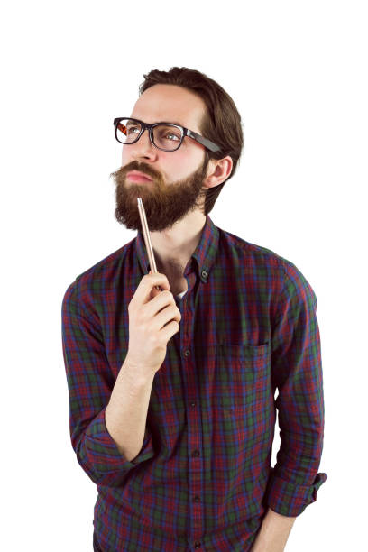 istock Handsome hipster thinking and holding pen 667858494