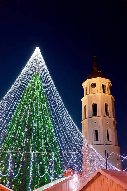 istock Christmas tree and bell tower Vilnius in evening 667859376