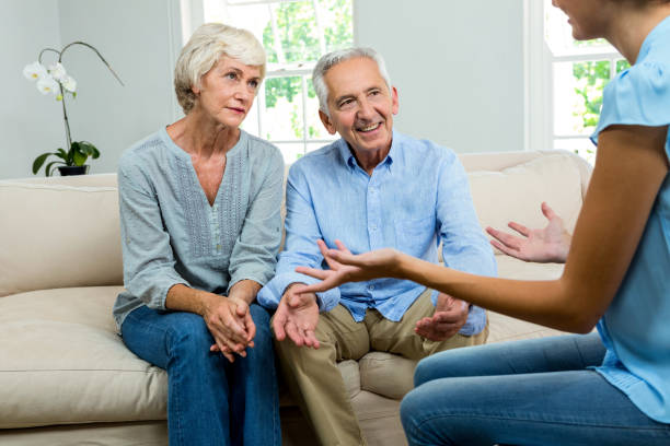 istock Female consultant explaining senior couple at home 667866492