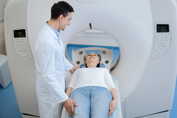 istock Pleasant handsome oncologist standing near his patient 667866796