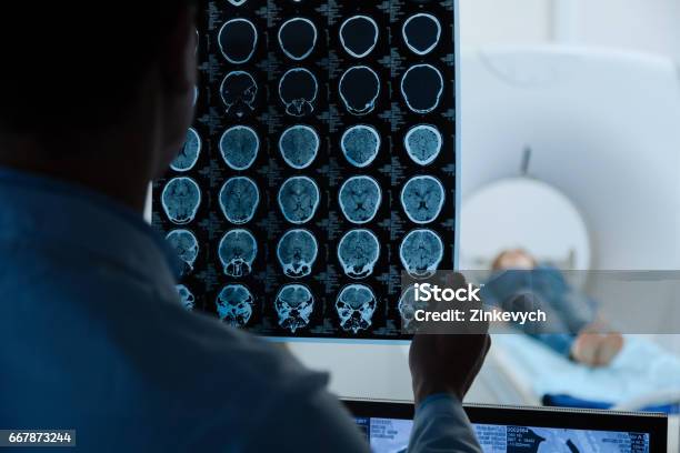 Mri Scan Images Being Examined By A Doctor Stock Photo - Download Image Now - Neurosurgery, Human Nervous System, Radiologist