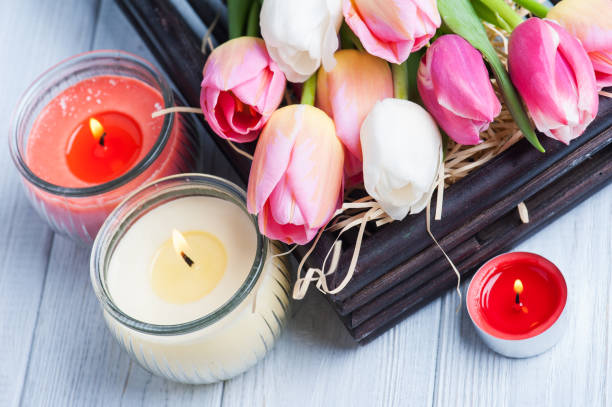 istock Yellow and pink aroma candles with tulips 667873346