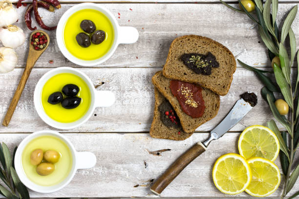 istock Bread slices and olive oil on wood 667873498