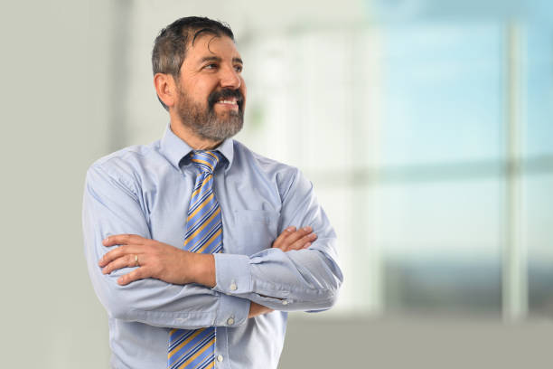 istock Hispanic Businessman Smiling with Arms Crossed 667877766
