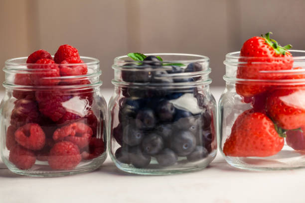 istock Glass jars of fresh berries 667880444