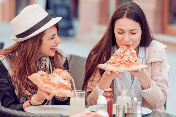 istock Friends eating pizza 667893972