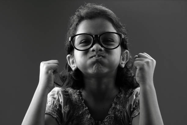 istock Little girl with a big spectacle shows  gestures 667904690