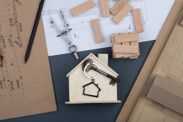 istock little house, key, wooden blocks, construction drawings, engineering tools 667913348