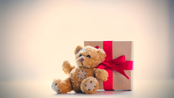 istock cute teddy bear and beautiful gift on the wonderful white background 667920544