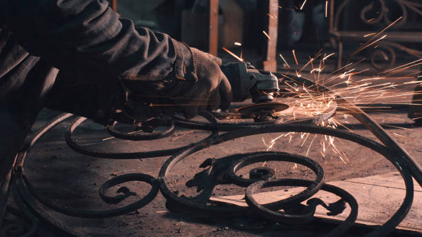 Smith smoothing metal grate Close up of man's hands smoothing metal grate metalwork stock pictures, royalty-free photos & images