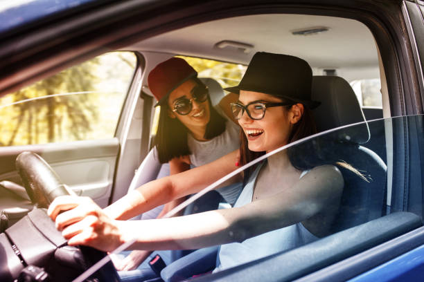 istock Two young women on car trip. 667926400