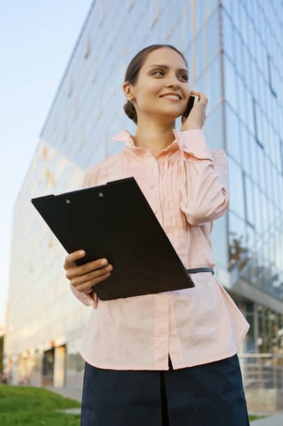 istock business woman speaks by mobile 667926800
