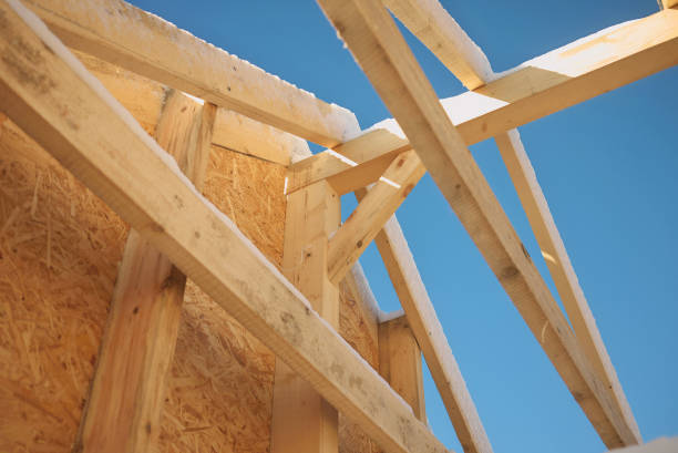 istock New home roof construction with wooden house frame 667942496