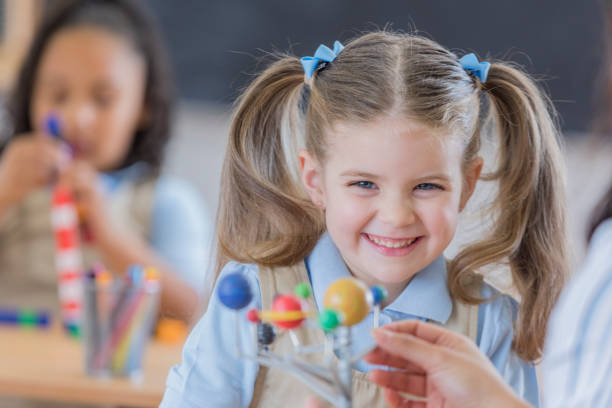 istock Happy schoolgirl in science class 667947046