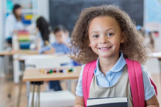 istock Confident kindergarten schoolgirl in her classroom 667947118