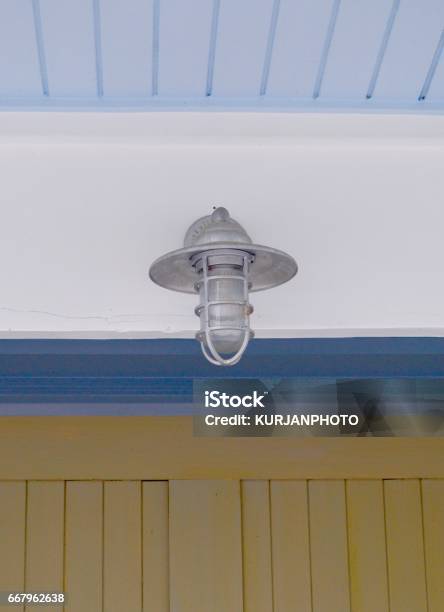 Outdoor Ceiling Light Fixture With Blue Ceiling Stock Photo - Download Image Now - Beadboard, Blue, Brown