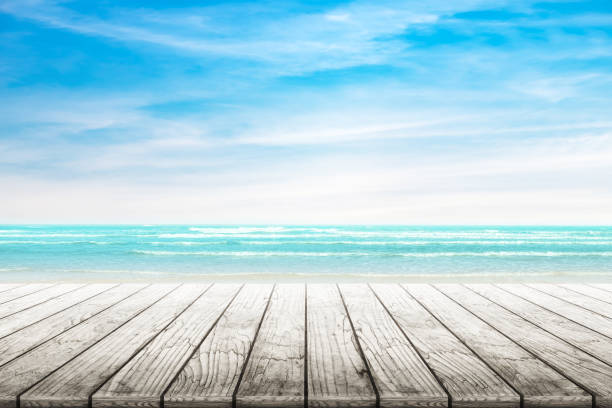 istock Empty wooden table with party on beach background blurred. 667962798
