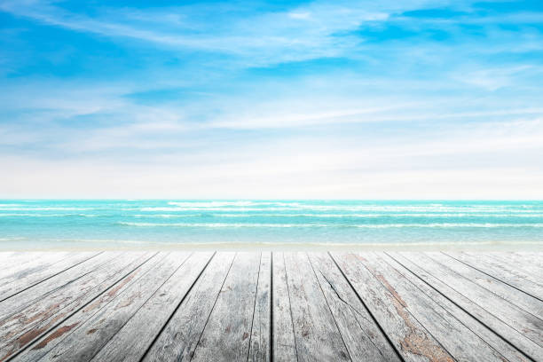 istock Empty wooden table with party on beach background blurred. 667963946