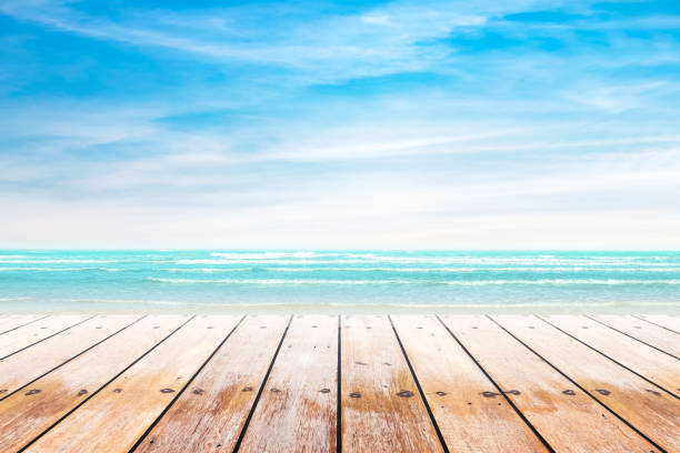 istock Empty wooden table with party on beach background blurred. 667966472