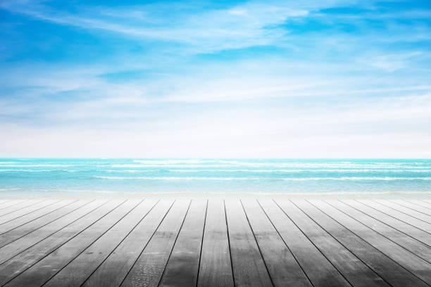 istock Empty wooden table with party on beach background blurred. 667966772