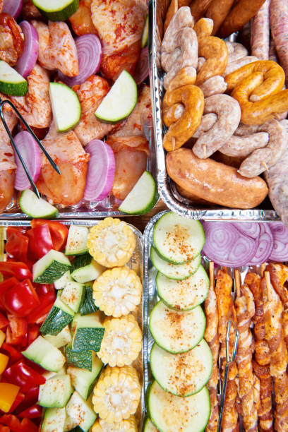 istock Marinated meat, sausages and vegetables prepared for grilling 667967362