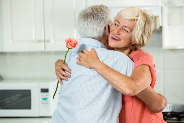 istock Smiling senior woman hugging man 667976772