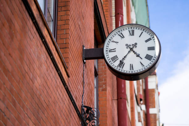 istock large street clocks on a brick wall 667983664