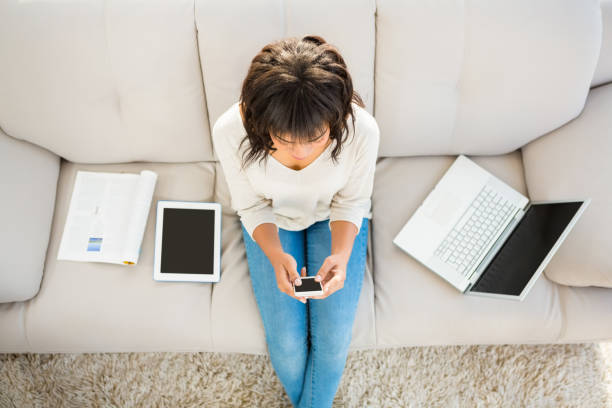 istock Smiling woman texting on her smartphone 667989064