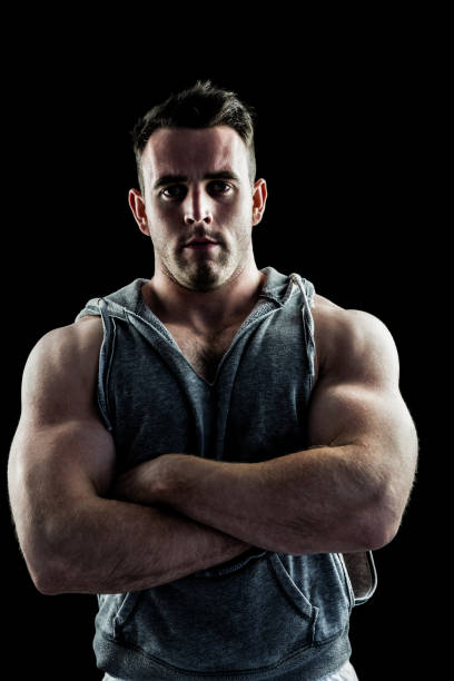 istock Handsome bodybuilder with arms crossed 667989130