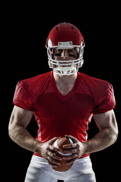 istock American football player holding ball 667992902