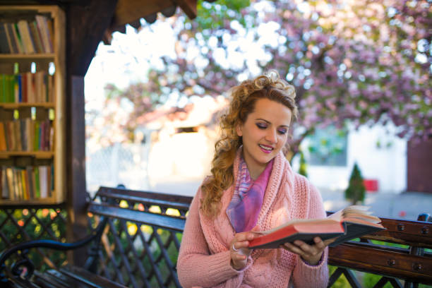 istock Female student in city garden library 667993044