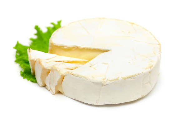 istock Gourmet cheese camembert with green lettuce isolated on white 667993600