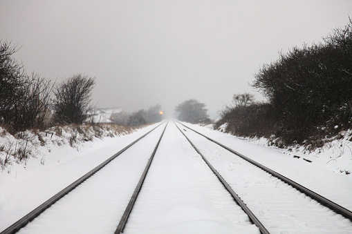 Kirchheim Teck, Germany, January 17 2024: Railway line Kirchheim to Stuttgart covered in snow with S-Bahn
