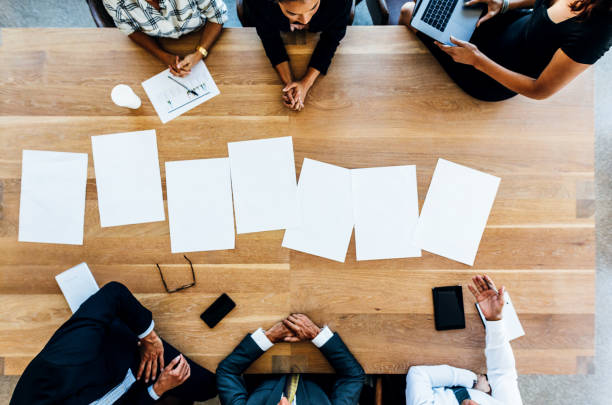 istock Blank placards on table with business people sitting around 667999024