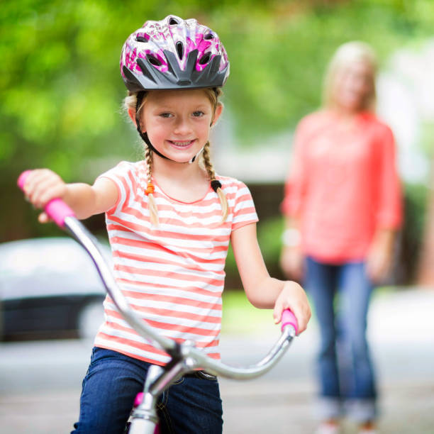 istock Father teaching daughter how to ride a bike. 668002834