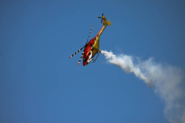 Bangalore, Karnataka, India - 02/16/2017 : Taken this picture at Aero India in Bangalore, India of Sarang team of Indian Air Force performing in front of thousands of spectators. This team comprised on Indian made Dhruv helicopters and one of the few aerobatics display in the world and well known around the world.