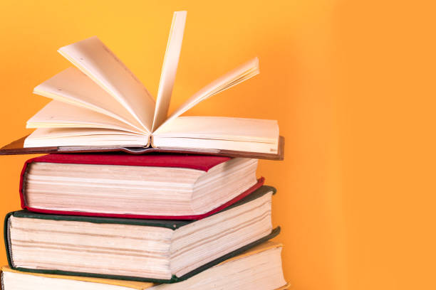 istock Open book, hardback books on bright colorful background. 668013142