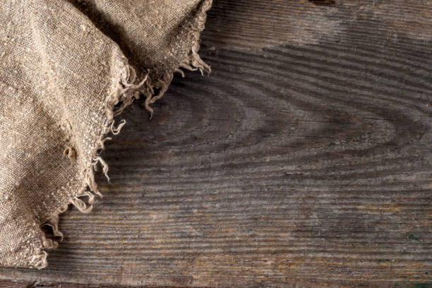 istock burlap hessian sacking on wooden background 668016930