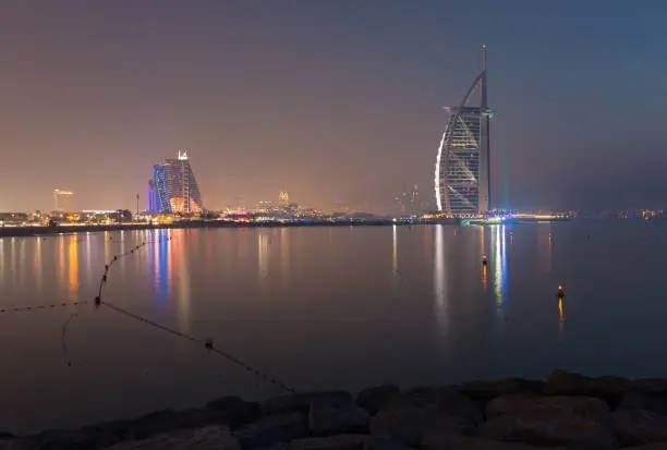 DUBAI, UAE - MARCH 30, 2017: The evening skyline with the Burj al Arab and Jumeirah Beach Hotels.