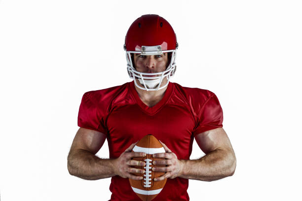 istock American football player holding ball 668026530